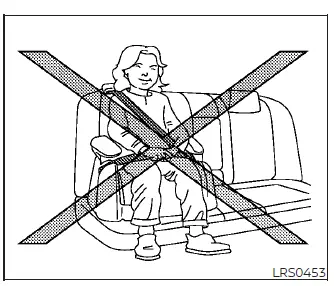 A child sitting correctly in a booster seat inside a Nissan Versa with the seat belt crossing the middle of the shoulder and resting low over the hips