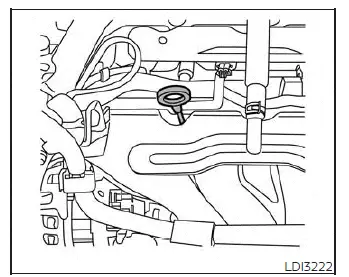 Locating the engine oil dipstick under the hood of a Nissan Versa