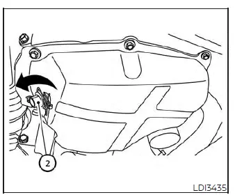Accessing the oil drain plug underneath the engine oil pan of a Nissan Versa
