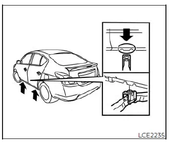 Detailed view of wheel nut loosening steps using a wrench on a Nissan Versa