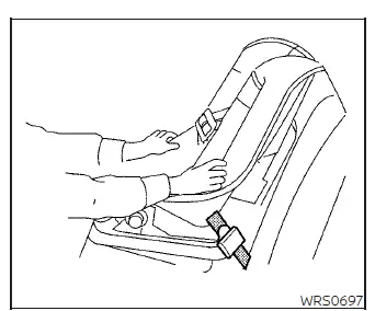 Testing the stability of the installed forward-facing child safety seat by firmly shaking it from side to side in a Nissan Versa