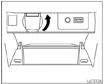 Location of the 12V 120W DC power outlet on the lower center stack of the Nissan Versa instrument panel