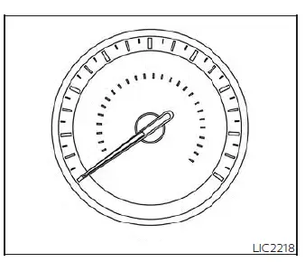 Close-up of the analog speedometer dial in the Nissan Versa showing speed readings in mph and km/h