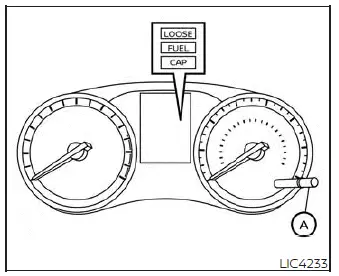 Close-up of the steering wheel menu controls showing the reset button location used to clear vehicle warning messages on the Nissan Versa