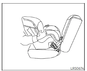 Testing the stability of the installed child restraint by pushing it side to side near the LATCH attachment path inside a Nissan Versa