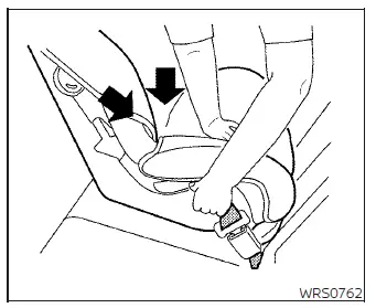 Pushing down on the center of the child restraint while pulling up on the shoulder belt to secure it tightly in a Nissan Versa