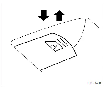 Close-up of the driver's automatic one-touch power window switch being pushed down on the Nissan Versa